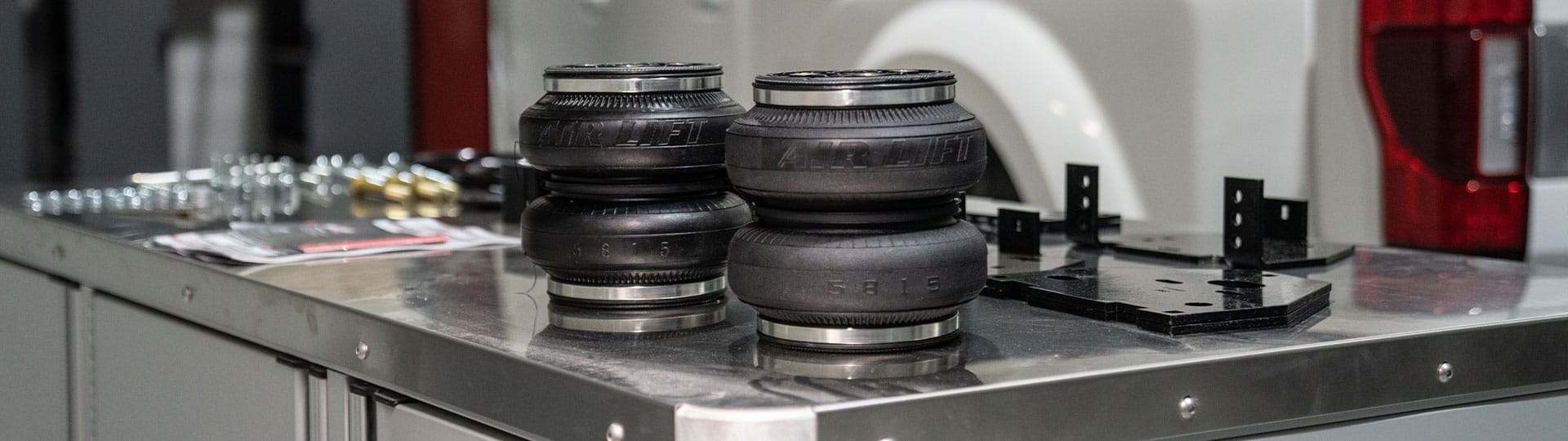 Two air springs with parts and pieces on a table